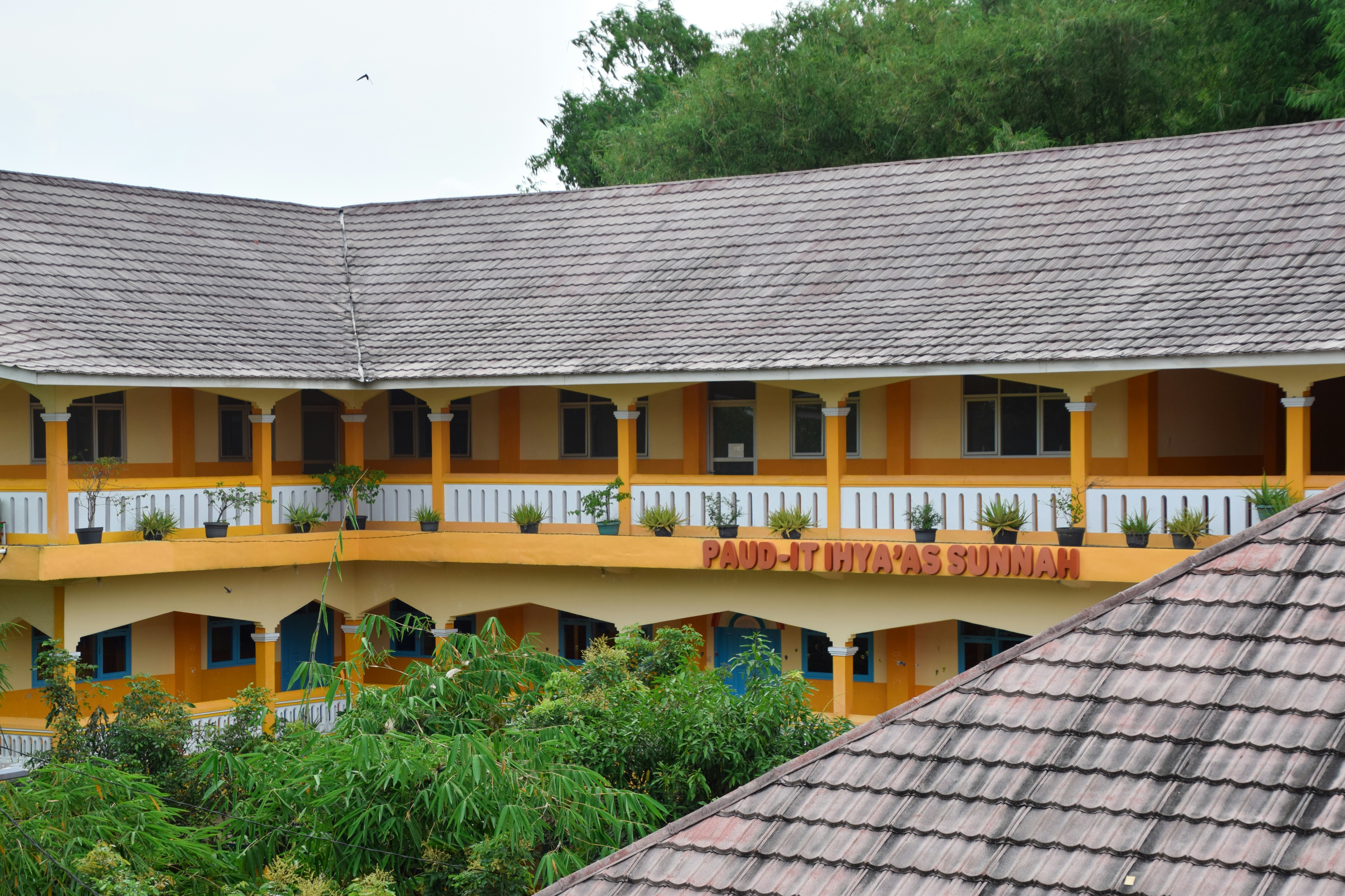 a yellow and white building with a sign on it